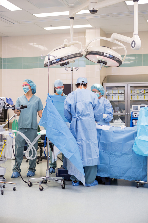 Surgical team operating on patient in theater