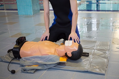 Instructor is sitting near mannequin - drowning in training cent