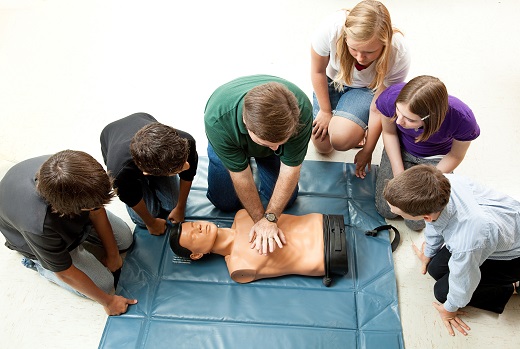 Group of teenagers learing CPR (cardiopulmonary resuscitation) i